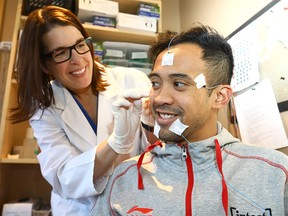 Amy Bender, Clinical Program Director Athletic Services for Centre For Sleep and Human Performance with client Olympic speedskater Gilmore Junio as Bender developed a first-of-its-kind online tool that accurately identifies sleep disturbances in elite athletes and recommends effective treatment plans, ultimately improving their athletic performance in Calgary on Tuesday December 12, 2017. Darren Makowichuk/Postmedia