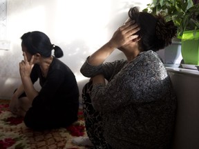 In this photo taken Friday, Sept. 8, 2017, North Korean women react during a meeting in a home near the city of Chaoyang in northeastern China's Liaoning province.