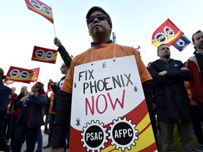 Public servants protest over problems with the Phoenix pay system outside the Office of the Prime Minister and Privy Council in Ottawa on October 12, 2017.