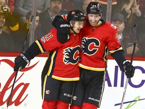 Flames Mikael Backlund (L) celebrates with teammate Dougie Hamilton on Hamilton's first period goal during NHL action between the Calgary Flames and Vancouver Canucks in Calgary on Tuesday, November 7, 2017. Jim Wells/Postmedia