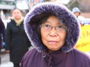 Jinling Huang is pictured with a small group of protestors outside of the Chinese consulate in downtown Calgary on Sunday, December 3, 2017. Huang's daughter, Yinghua Chen, has allegedly been held in China since 2014. Protesters want Prime Minister Trudeau to urge Chinese leaders to unconditionally release  Canadians allegedly illegally incarcerated for practicing Falun Gong. Jim Wells/Postmedia