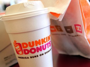 A cup of Dunkin' Donuts coffee and a donut bag sit on a counter September 7, 2006 in Chicago, Illinois.
