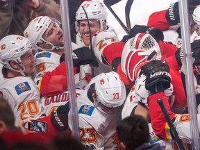 Calgary Flames centre Sean Monahan (No. 23) is mobbed by teammates after scoring the winning goal against the Montreal Canadiens during overtime NHL hockey action Thursday, December 7, 2017 in Montreal.