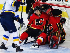 Calgary Flames defenceman Travis Hamonic is pushed into goaltender Mike Smith on Nov. 13, 2017