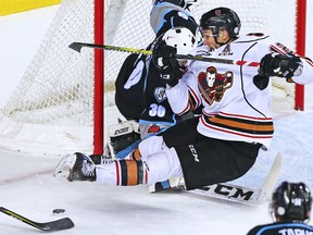 Calgary Hitmen star Mark Kastelic fights for control of the puck in front of Kootenay Ice goaltender Duncan McGovern during WHL action at the Scotiabank Saddledome in Calgary, Thursday December 28, 2017.