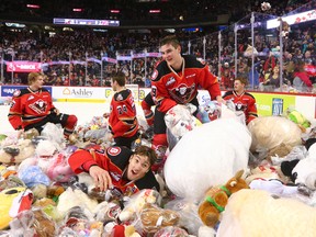 The Calgary Hitmen celebrate a sea of stuffies after Vladislav Yeryomenko scored the first goal in the Teddy Toss game against the Moose Jaw Warriors in Calgary on Sunday December 10, 2017.