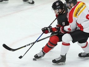 Canada's Dillon Dube (9) works against Switzerland's Livio Stadler during first period World Junior exhibition hockey action in Hamilton, Ont., on Friday, December 22, 2017.