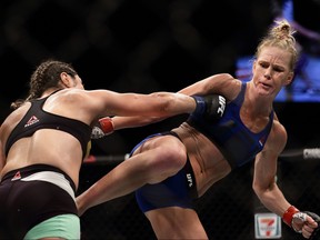 Holly Holm (right) fights Bethe Correia during UFC Singapore Fight Night at Singapore Indoor Stadium on June 17, 2017 in Singapore.