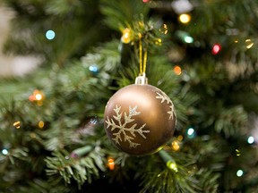 An ornament hangs from an artificial Christmas tree on display inside a Home Depot store in New York, U.S., on Thursday, Nov. 19, 2009. Home Depot Inc., the world's largest home-improvement chain, and second-biggest Lowe's Cos. are stocking fewer artificial Christmas trees as shoppers seek to trim holiday spending. Photographer: Daniel Acker/Bloomberg