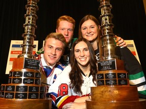 Calgary Buffaloe's Sam Anderson, Okotoks Bow Mark Oilers' Joel Krahenbil, Calgary Fire  Mackenzie Lausberg and Rocky Mountain Raiders' Breanne Trotter pose with the Championship trophies  as the Mac's Tournament Committee announced the 33 participating teams in the 40th annual Mac's AAA Midget Hockey Tournament at the Westin Hotel.
