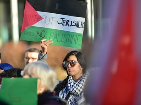 A protestor rallies at Calgary city hall on Saturday opposed to U.S. President Donald Trump's recognition of Jerusalem as the capital of Israel. Bryan Passifiume/Postmedia Network