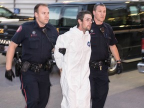 Daniel Loveys, 28, escorted into arrest processing on Aug. 10 2017. Bryan Passifiume/Postmedia Network