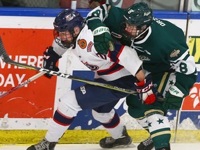 The Calgary Northstars' AJ Belanger (right) tries to corral the Regina Pat Canadians' Reece Henry during the Mac's AAA Midget Hockey Tournament at Max Bell Centre in Calgary on Saturday, December 30, 2017.