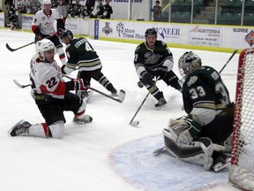 Camrose Kodiaks' Nic Correale splits Okotoks Oilers' Ayden Roche-Setoguchi and Riley Mathies as he breaks in on goalie Riley Morris on March 12, 2017