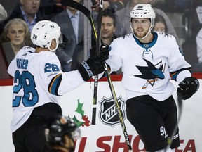 San Jose Sharks' Chris Tierney, right, celebrates his goal with teammate Timo Meier, from Switzerland, during second period NHL hockey action against the Calgary Flames in Calgary, Thursday. Photo by Jeff McIntosh/The Canadian Press.