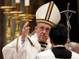 Pope Francis delivers a blessing at the end of the Christmas Eve Mass in St. Peter's Basilica at the Vatican, Sunday, Dec. 24, 2017. (AP Photo/Alessandra Tarantino)