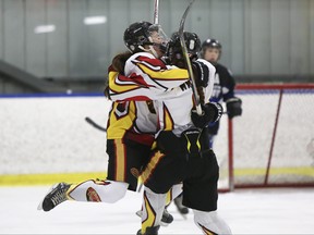 Regina Rebels' Hanna Bailey jumps into the arms of teammate Kate Wagner after teammate Lauren Focht scored the first goal of the game (1-0) as the Regina Rebels play the Swift Current Wildcats in second-period, round-robin female hockey action during the Mac's AAA Midget Hockey Tournament at the Max Bell Centre on Friday, Dec. 29, 2017 in Calgary. (Britton Ledingham/Postmedia Network)