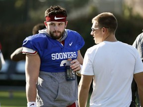 Oklahoma quarterback Baker Mayfield takes a breather after he participated in drills during a short segment of Rose Bowl practice that was open to the media, Friday, Dec. 29, 2017, in Carson, Calif. Oklahoma plays Georgia in a semifinal of the College Football Playoff on New Year's Day.
