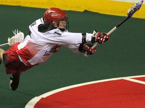 Calgary Roughnecks Curtis Dickson makes a flying shot against the Rochester Knighthawks in NLL action at the Scotiabank Saddledome.