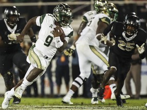 Quinton Flowers #9 of the South Florida Bulls runs the ball during the second half against the UCF Knights at Spectrum Stadium on November 24, 2017 in Orlando, Florida. UCF Knights defeated South Florida Bulls 49-42.