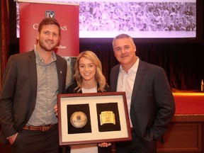 From left, Shaw Charity Classic staffers Rhys Royer, Lauren Calvert and Sean Van Kesteren show off the President’s Award, the highest honour for a PGA Tour Champions event.
