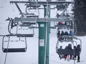 Skiers on a chair lift at Lake Louise.