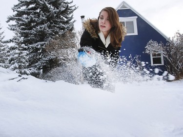 Emily Nelson brushes the snow off her car after the first big snowfall of the season. Wednesday, December 20, 2017.