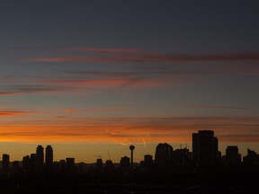The Calgary skyline is silhouetted at sunset from a vantage point at the Calgary Herald on Friday, Dec. 8, 2017 in Calgary, Alta. Britton Ledingham/Postmedia Network
