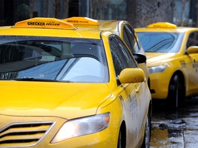 Taxi cabs wait for fares n downtown Calgary.