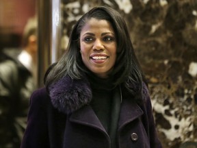 In this Dec. 13, 2016 file photo, Omarosa Manigault smiles at reporters as she walks through the lobby of Trump Tower in New York. The White House says Omarosa Manigault Newman, one of President Donald Trump's most prominent African-American supporters, plans to leave the administration next month.