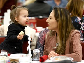 Larissa Starlight and her daughter, Araya,18 months, attend the annual Tsuut'ina Nation Christmas Feast and Procession at the Grey Eagle Event Centre on Dec. 28, 2017.