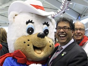 Naheed Nenshi, Calgary mayor, takes part in an impromptu dance with Calgary Olympic mascot Hidy, during an event marking the 25 year anniversary of the 1988 winter Olympics at the Olympic Oval in 2013.