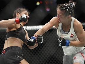 Cynthia Calvillo, left, fights Carla Esparza in a strawweight mixed martial arts bout at UFC 219, Saturday, Dec. 30, 2017, in Las Vegas.