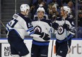 Jets’ Nikolaj Ehlers (centre) celebrates one of his two goals last night against Buffalo. Ehlers had gone nine games without a tally. (AP PHOTO)