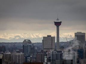 The Rocky Mountains sit behind the skyline in Calgary, Alta., on Monday, March 20, 2017.
