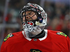 Jeff Glass of the Chicago Blackhawks rests during a break in the action against the Vegas Golden Knights at the United Center on Jan. 5, 2018 in Chicago.