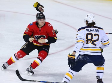 The Calgary Flames' Curtis Lazar throws his gloves before fighting the Buffalo Sabres' Nathan Beaulieu during NHL action at the Scotiabank Saddledome on Calgary on Monday January 22, 2018.