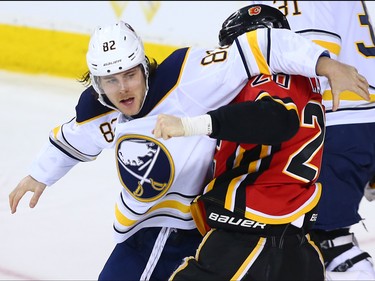 The Calgary Flames' Curtis Lazar fights the Buffalo Sabres' Nathan Beaulieu during NHL action at the Scotiabank Saddledome on Calgary on Monday January 22, 2018.