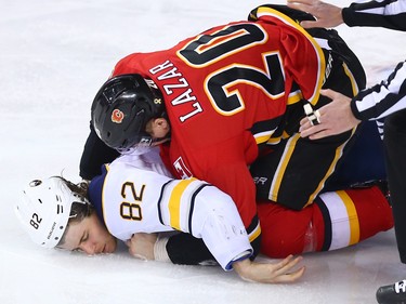 The Calgary Flames' Curtis Lazar fights the Buffalo Sabres' Nathan Beaulieu during NHL action at the Scotiabank Saddledome on Calgary on Monday January 22, 2018.