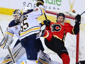 The Buffalo Sabres' Rasmus Ristolainen knocks over the Flames' Troy Brouwer at Scotiabank Saddledome on Jan. 22, 2018.