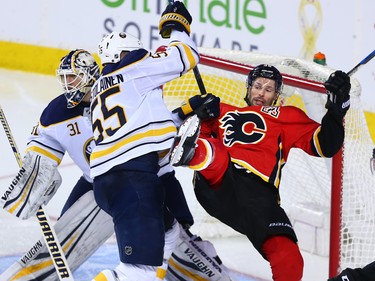 The Buffalo Sabres' Rasmus Ristolainen knocks over the Calgary Flames' Troy Brouwer during NHL action against the Calgary Flames at the Scotiabank Saddledome on Calgary on Monday January 22, 2018. The Sabres won 2-1 in overtime.
