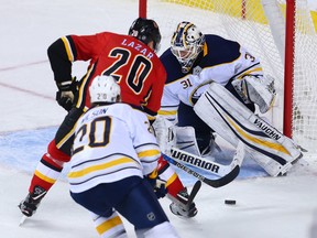 The Calgary Flames' Curtis Lazar is stopped by Buffalo Sabres goaltender Chad Johnson during NHL action in Calgary on Monday January 22, 2018. The Sabres won 2-1 in overtime.