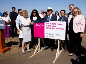 Premier Rachel Notley, left, and Alberta Health Minister Sarah Hoffman, right, unveil a sign during a press conference near Ellerslie Road and 127 Street to announce Edmonton's new hospital project in Edmonton on Tuesday, May 30, 2017.