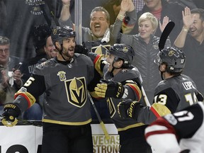 Vegas Golden Knights defenseman Deryk Engelland, left, celebrates after scoring against the Arizona Coyotes during the first period of an NHL hockey game Tuesday, Oct. 10, 2017, in Las Vegas. (AP Photo/John Locher) ORG XMIT: NVJL112