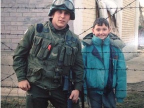 Justin Frye, left, poses with Amir Bagramovic, a Bosnian child he met while stationed in the war-torn country with the United Nations in 1994 in this handout photo.