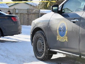 A vehicle belonging to Alberta's Office of the Chief Medical Examiner at the scene of a suspicious death in Calgary, Alta. on Thursday, Jan. 4 2018. Bryan Passifiume/Postmedia Networkj