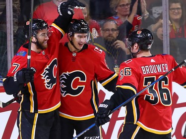 The Calgary Flames TJ Brodie, left celebrates with Mikael Backlund and Troy Brouwer after scoring on Winnipeg Jets goaltender Connor Hellebuyck during NHL action at the Scotiabank Saddleome in Calgary on Saturday  January 20, 2018.