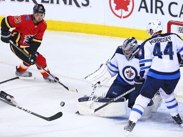 The Calgary Flames' Johnny Gaudreau circles for a rebound after a shot on Winnipeg Jets goaltender Connor Hellebuyck during NHL action at the Scotiabank Saddleome in Calgary on Saturday January 20, 2018.