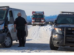 A Calgary Fire Department hazardous materials vehicle leaves a rural property as police guard the entrance during a Calgary Humane Society animal cruelty investigation on Tuesday January 23, 2018.