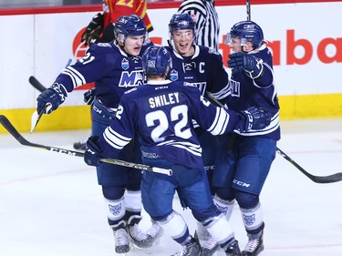 Mount Royal University Cougars celebrate scoring on the University of Calgary during the Crowchild Classic at the Scotiabank Saddledome in Calgary, Thursday January 25, 2018.